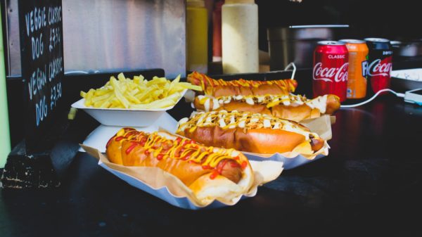 four hotdog sandwiches on desk